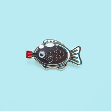 Dive into the whimsical world of Japanese cuisine with our adorable soy fish enamel pin!