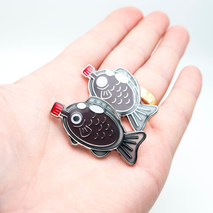 Get hooked on cuteness with our kawaii soy fish pin, inspired by Tokyo's culinary delights.