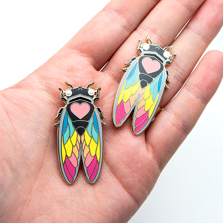 Stylish presentation of the Nature-inspired Rainbow Cicada Pin, highlighting its 1.5-inch size and gold-plated metal accents.