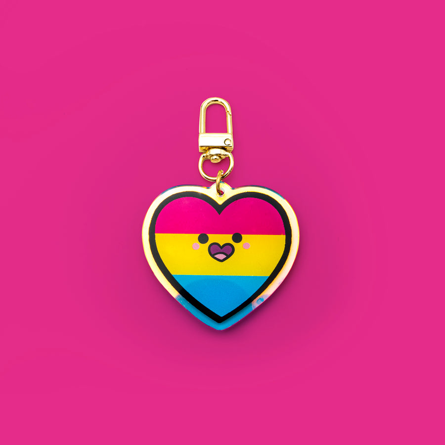 Pride rainbow keychain with glitter epoxy, acrylic material, and a 2-inch size. Features a gold clip hook for easy attachment, symbolizing attraction to all genders in a vibrant, inclusive design.

