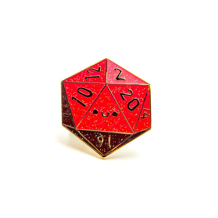 The D20 enamel pin displayed on a card, packaged inside a protective cello sleeve.