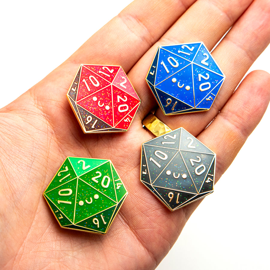 A glittery red D20 enamel pin with two backing posts and rubber clutches.