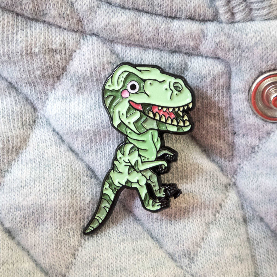 green tyrannosaurus rex pin on gray denim