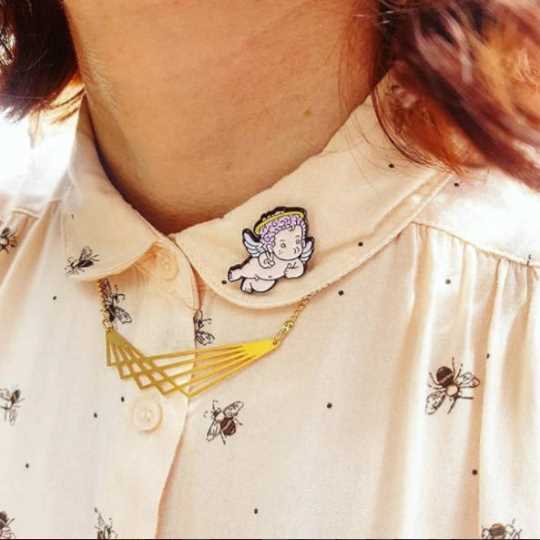 angel lapel pin on shirt