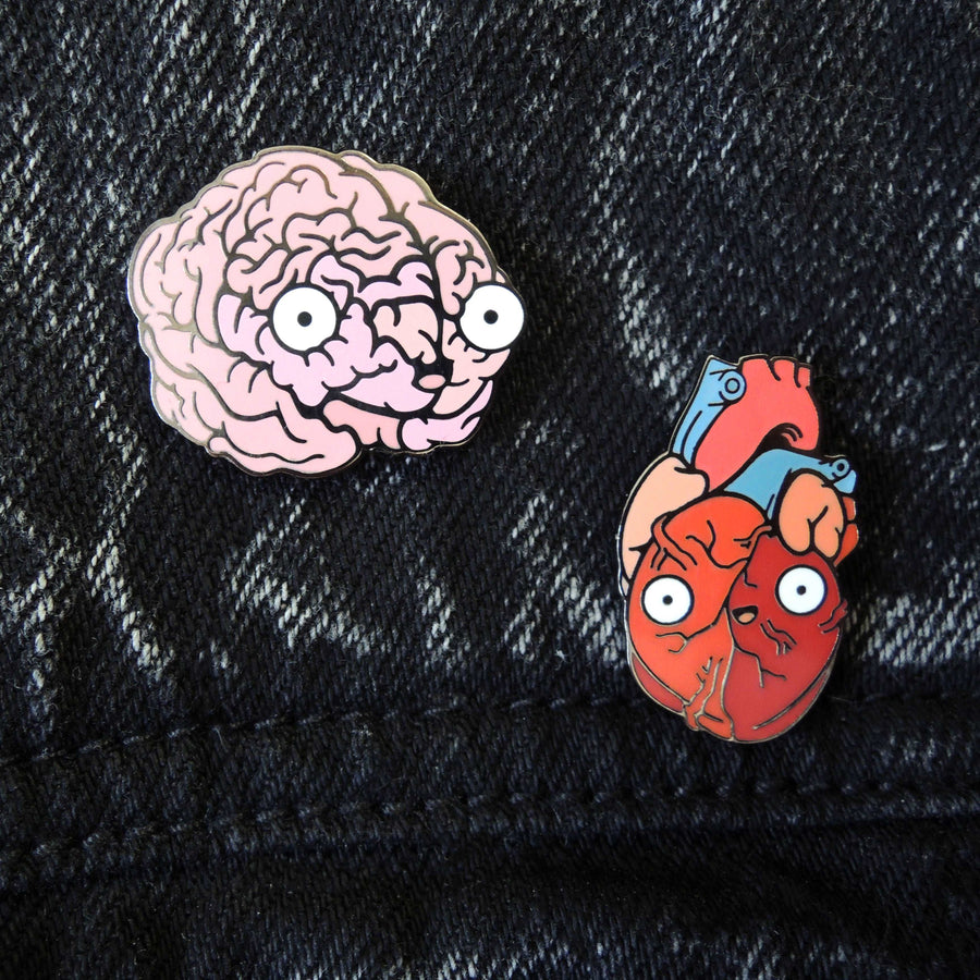 heart and brain lapel pin on black denim